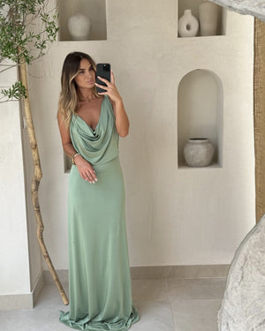 woman wearing light green draped maxi dress in stylish room