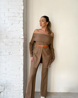woman wearing brown off shoulder dress with orange belt