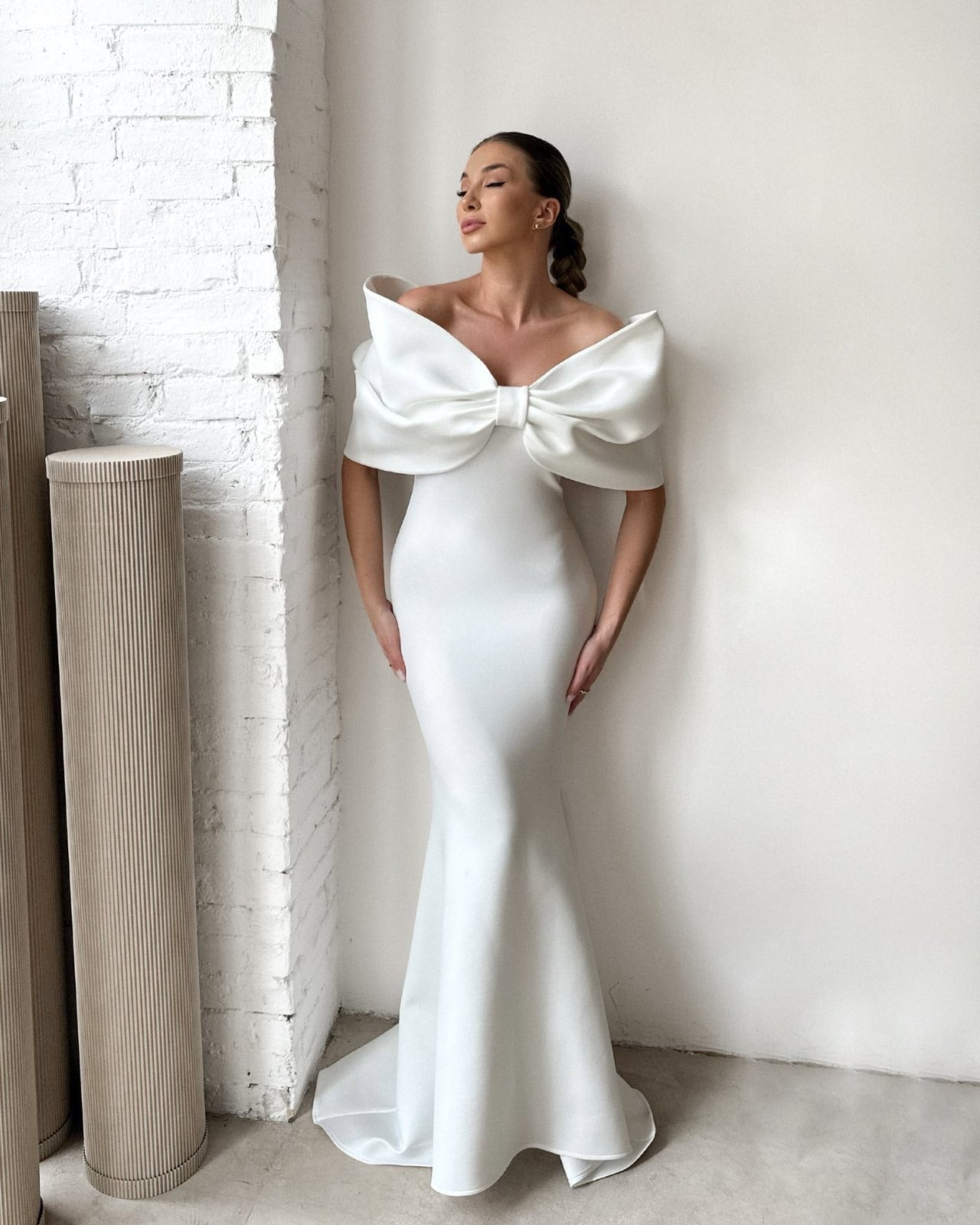 elegant white mermaid gown with large bow detail