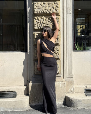 woman wearing elegant black dress in sunlight
