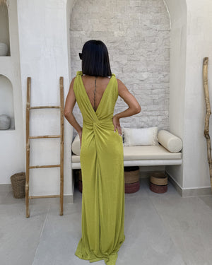 black haired woman in long backless green dress