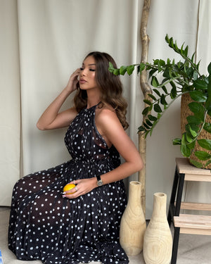 woman in black polka dot dress holding lemon