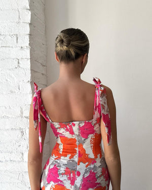 woman in colorful sleeveless dress back view