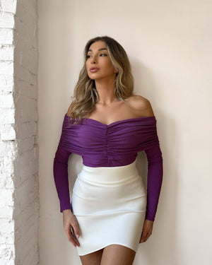 woman in purple off shoulder top and white skirt