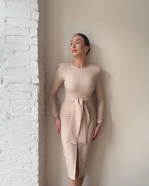 woman in beige long sleeve dress with belted tie and slit