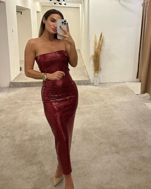 woman in red sequin strapless dress taking mirror selfie