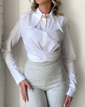woman wearing white blouse and light gray trousers