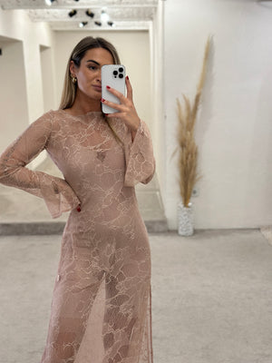 woman in beige lace long sleeve dress taking selfie