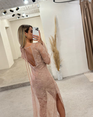 woman wearing pink lace dress with open back