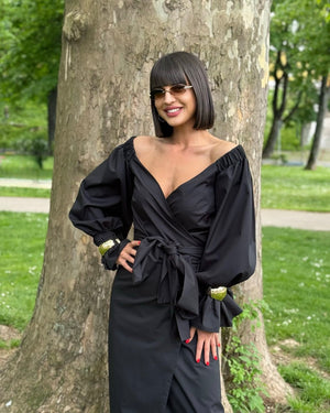 woman wearing black off shoulder dress outdoors