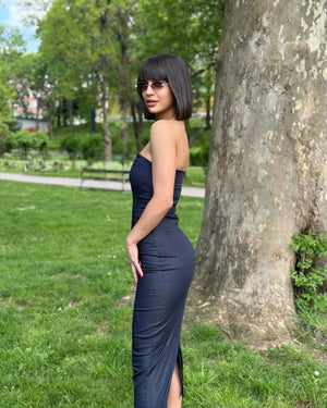 woman in dark sleeveless dress in park