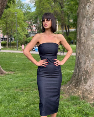sleek strapless black dress in park setting