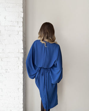 woman in blue kimono style dress