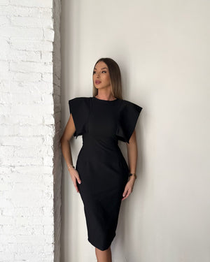 elegant black dress on woman in minimalist setting