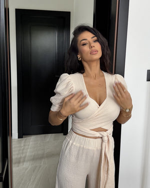 woman wearing beige wrap dress