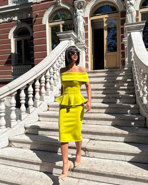woman wearing off shoulder yellow dress on stairs