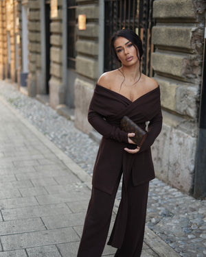 woman in brown off shoulder jumpsuit outdoors