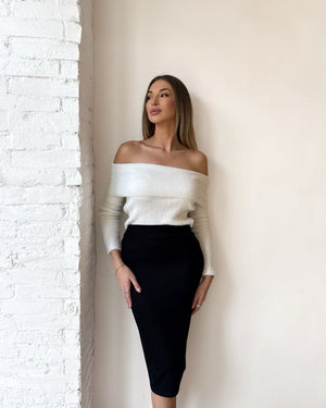 woman wearing off shoulder sweater and black skirt