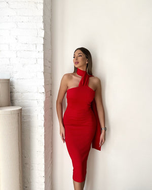 woman in red halter dress standing indoors