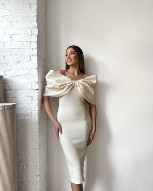 elegant cream dress with large bow design