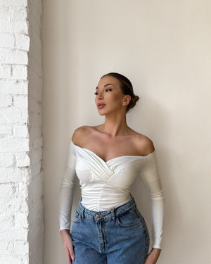 white off shoulder top and blue jeans