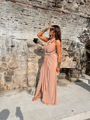 woman in beige maxi dress standing outside