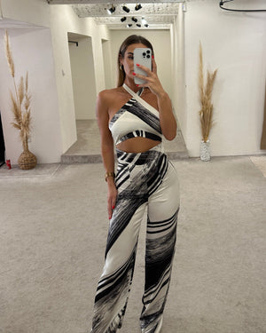 woman wearing halter top black and white patterned pants in dressing room