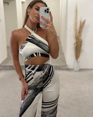 woman in black and white abstract pattern dress taking selfie
