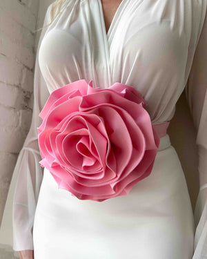 white dress with large pink flower detail