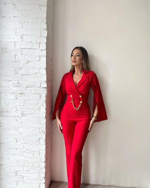 woman wearing red jumpsuit with chain detailing