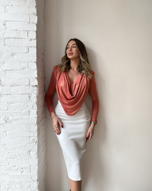 woman wearing salmon top and white pencil skirt