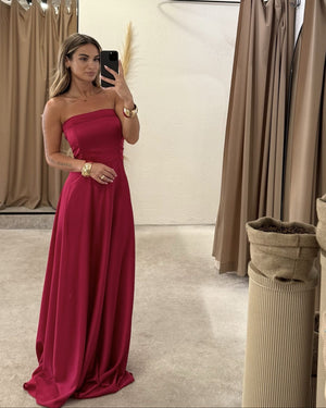 woman wearing red strapless evening gown in fitting room