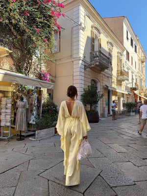 woman in yellow dress walking down street