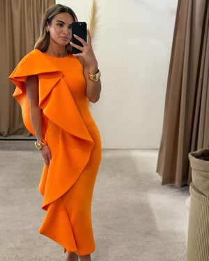 orange ruffled dress in fitting room