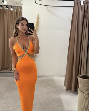 orange dress with gold details in dressing room