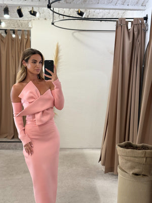 woman in pink off shoulder dress in fitting room