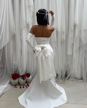 back view of elegant strapless white gown with large bow