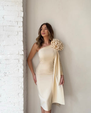 woman in elegant one shoulder cream dress with floral detail