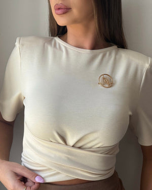 beige satin top with gold brooch